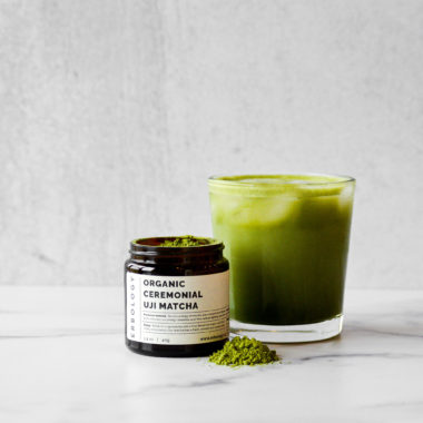 Matcha jar and latte with matcha powder on marble for cognitive health